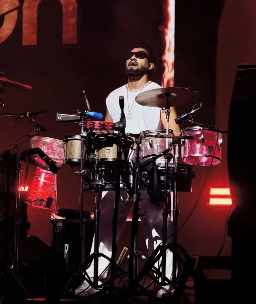 KKsonic live percussion under red stage lighting